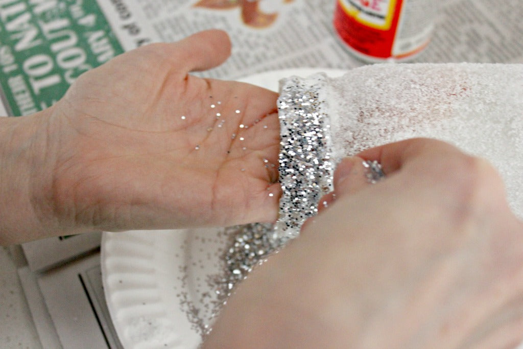 Sprinkle glitter over the Mod Podge on the edge of the Epsom salt luminaries